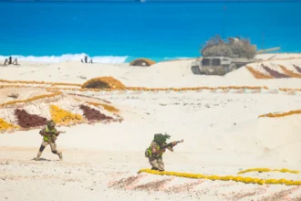 Αιγύπτιοι στρατιώτες με παραλλαγή κινούνται σε αμμώδες έδαφος κατά τη διάρκεια άσκησης