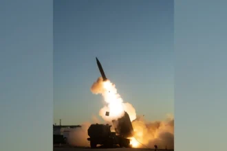 Εκτοξευτής HIMARS εκτοξεύει πύραυλο Precision Strike Missile με φλόγες και καπνό στο σούρουπο