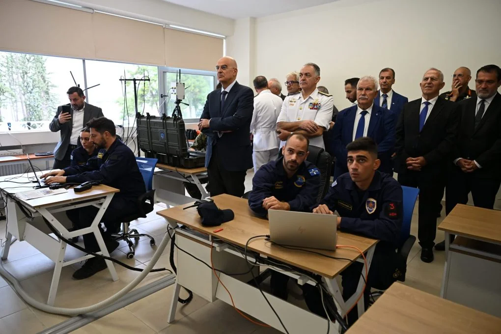 Στελέχη του Πολεμικού Ναυτικού εργάζονται σε υπολογιστές ενώ ο υπουργός και αξιωματικοί παρακολουθούν όρθιοι